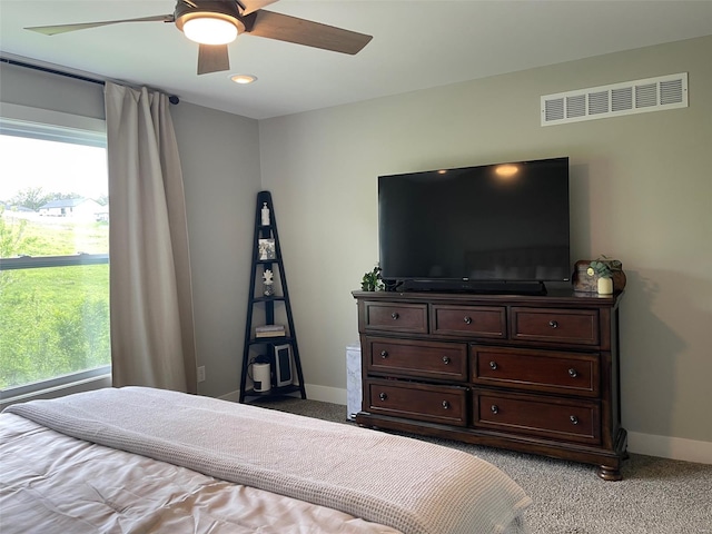bedroom with baseboards, multiple windows, and visible vents
