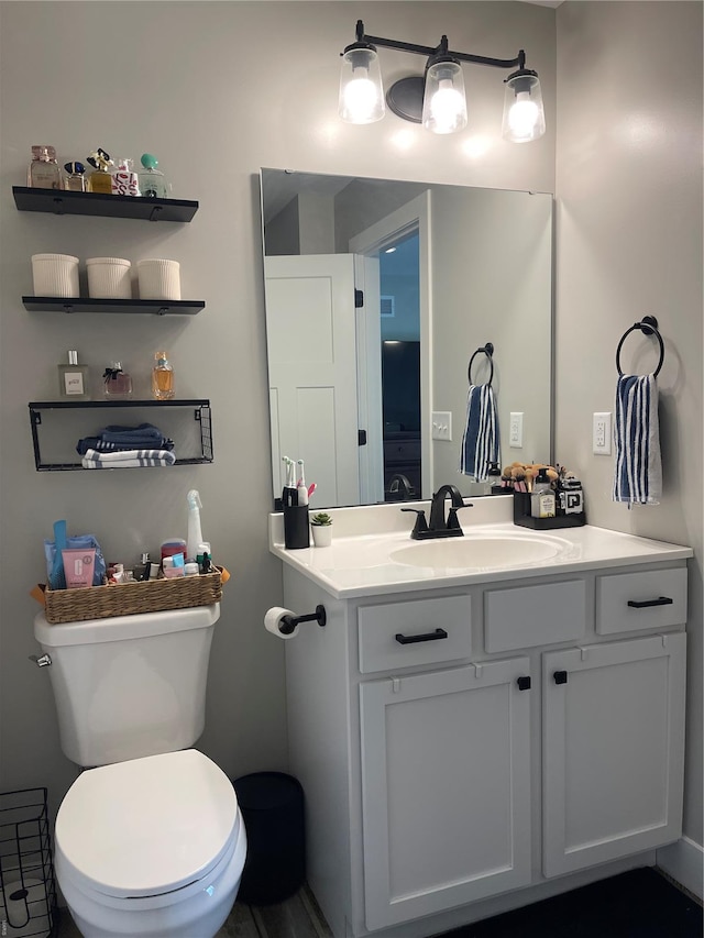 bathroom featuring vanity and toilet