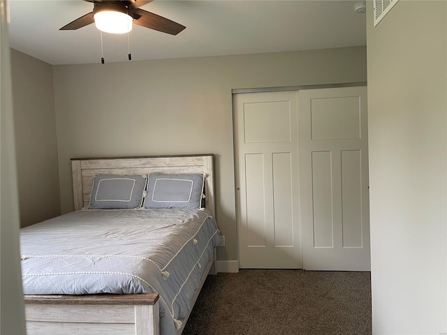 carpeted bedroom with a ceiling fan and a closet