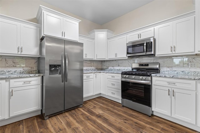 kitchen featuring stainless steel appliances, white cabinets, and decorative backsplash