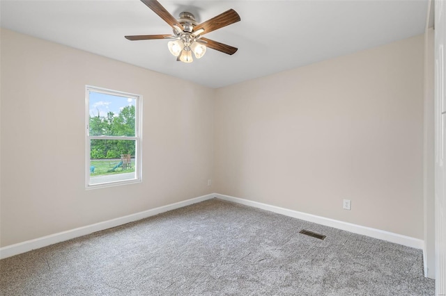 unfurnished room with baseboards, visible vents, ceiling fan, and carpet