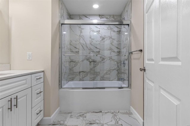 bathroom featuring marble finish floor, vanity, recessed lighting, combined bath / shower with glass door, and baseboards