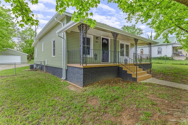view of front of home featuring a porch, fence, and a front lawn