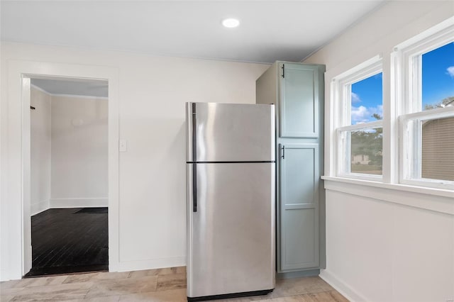 kitchen with freestanding refrigerator, recessed lighting, and baseboards