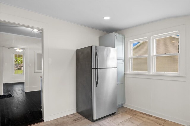 kitchen with baseboards, freestanding refrigerator, recessed lighting, and light wood-type flooring