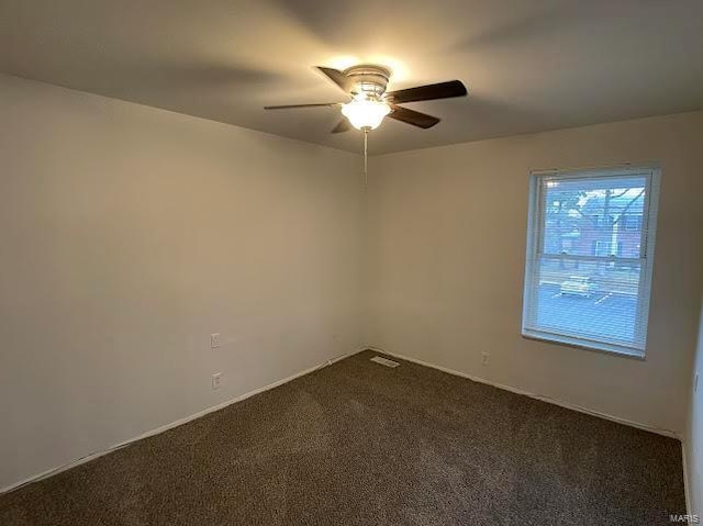 spare room featuring carpet and a ceiling fan