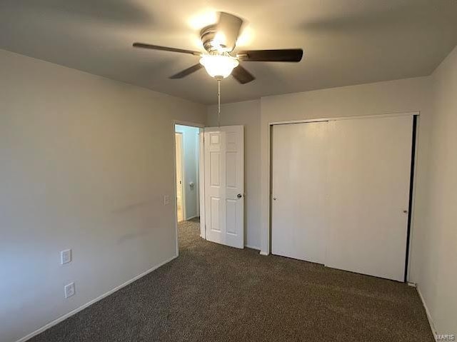 unfurnished bedroom featuring a closet, a ceiling fan, baseboards, and dark colored carpet