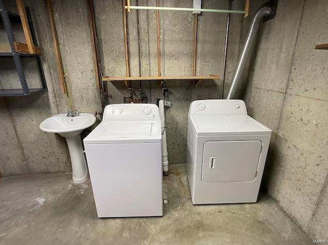 washroom featuring washing machine and dryer and a sink