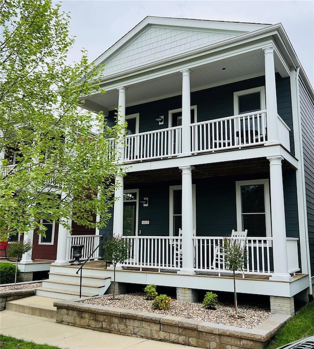greek revival inspired property with a porch and a balcony