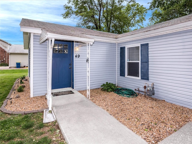 entrance to property with roof with shingles