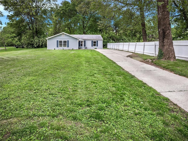 view of front of property with a front lawn and fence