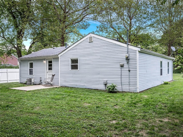 back of house featuring a yard, fence, a patio, and central AC