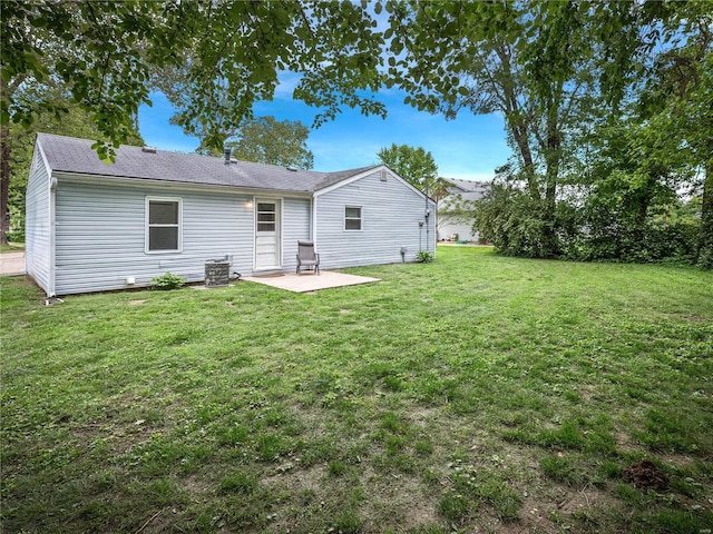 back of house featuring central AC unit, a patio, and a lawn