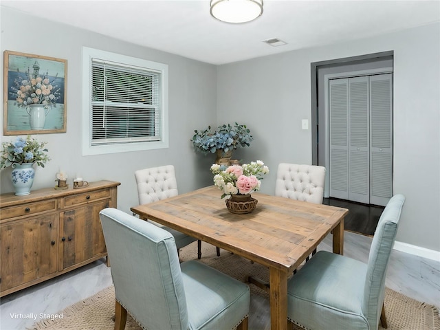 dining space featuring baseboards
