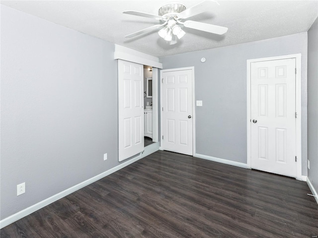 unfurnished bedroom with baseboards, dark wood finished floors, and ceiling fan