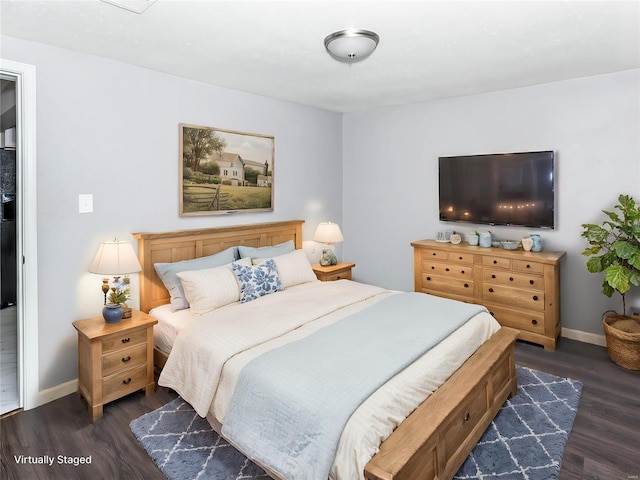 bedroom featuring dark wood finished floors and baseboards