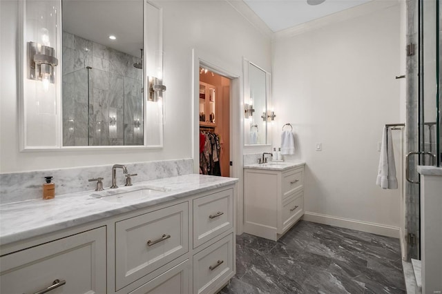 bathroom with crown molding, marble finish floor, a shower stall, and a sink