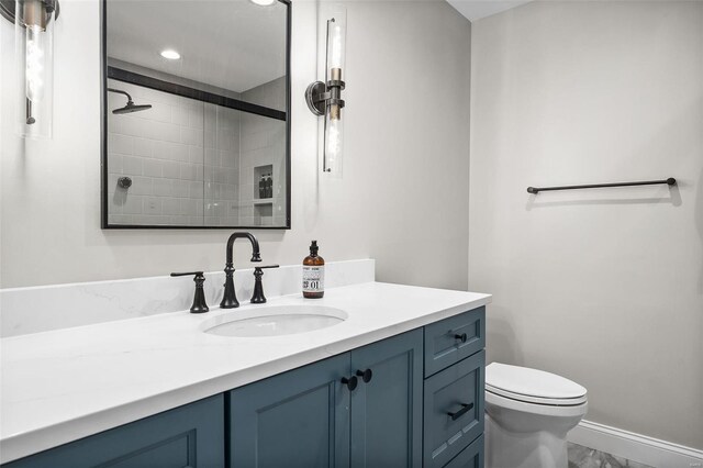 full bath with recessed lighting, toilet, marble finish floor, a tile shower, and vanity