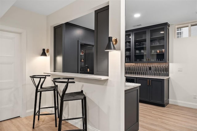 bar with baseboards and light wood-style floors