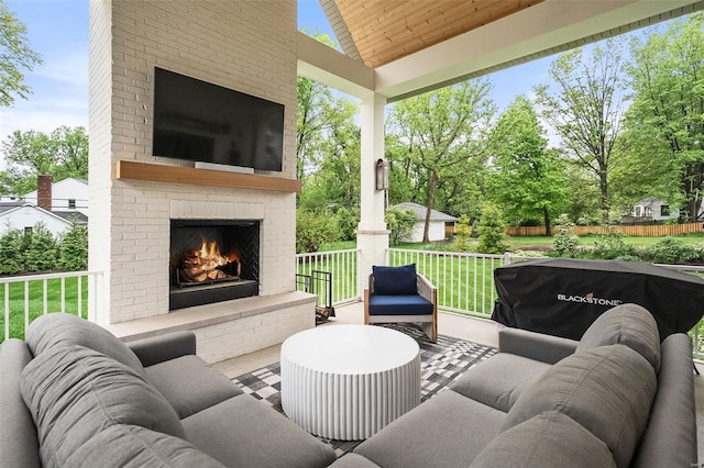 view of patio with an outdoor living space with a fireplace