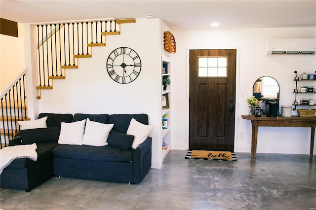 interior space featuring stairs, a wall mounted AC, baseboards, and concrete floors