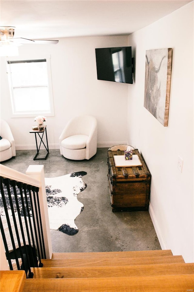 interior space with baseboards and ceiling fan