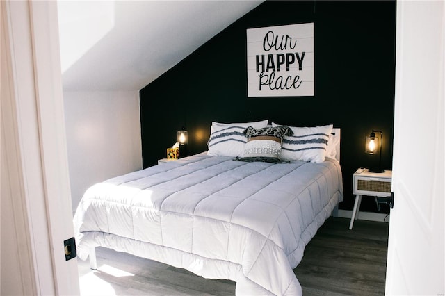 bedroom featuring lofted ceiling and wood finished floors
