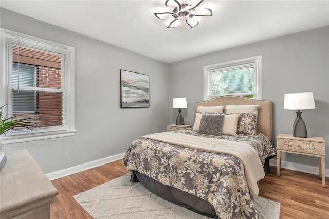 bedroom featuring baseboards and wood finished floors