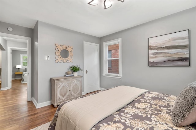 bedroom with wood finished floors and baseboards