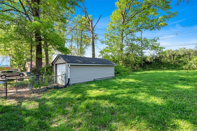 view of yard featuring an outdoor structure and fence