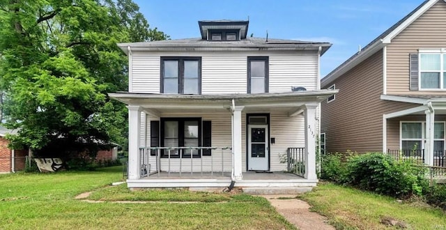 traditional style home featuring a porch and a front lawn