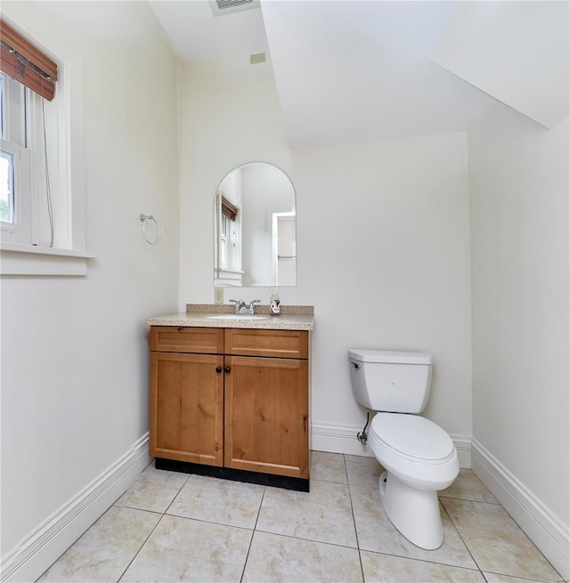bathroom featuring vanity, toilet, baseboards, and visible vents