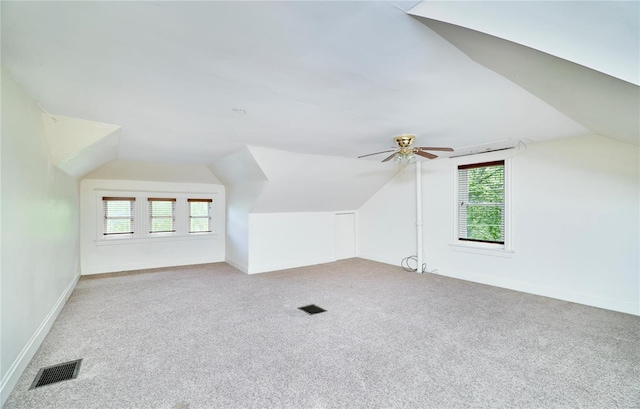 bonus room with a ceiling fan, carpet, baseboards, visible vents, and vaulted ceiling
