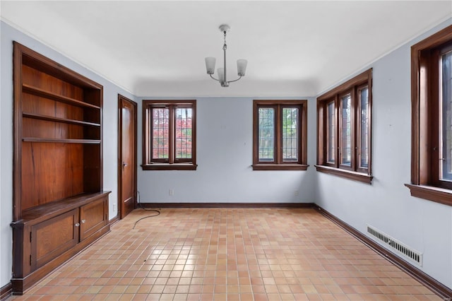 unfurnished dining area featuring a chandelier, visible vents, built in shelves, and baseboards