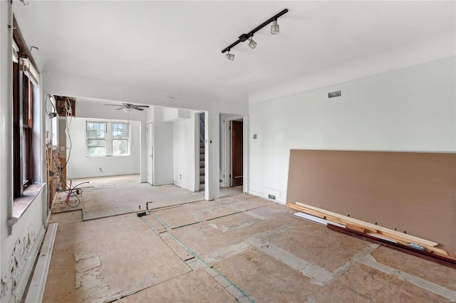 unfurnished room featuring visible vents and a ceiling fan
