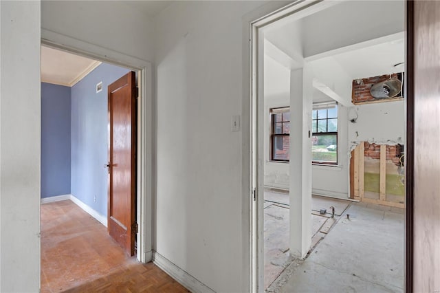 hall featuring crown molding and baseboards