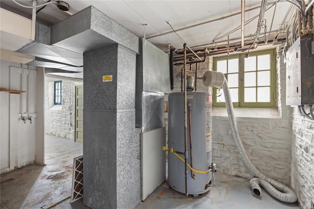 utilities featuring electric panel, gas water heater, and heating unit