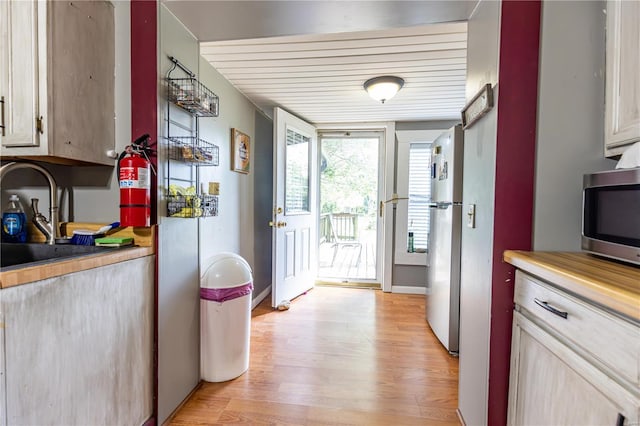 kitchen with light countertops, appliances with stainless steel finishes, and light wood-style flooring