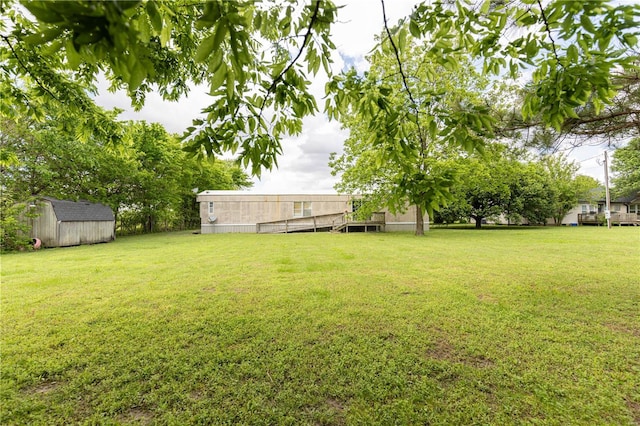 view of yard featuring a storage unit and an outbuilding