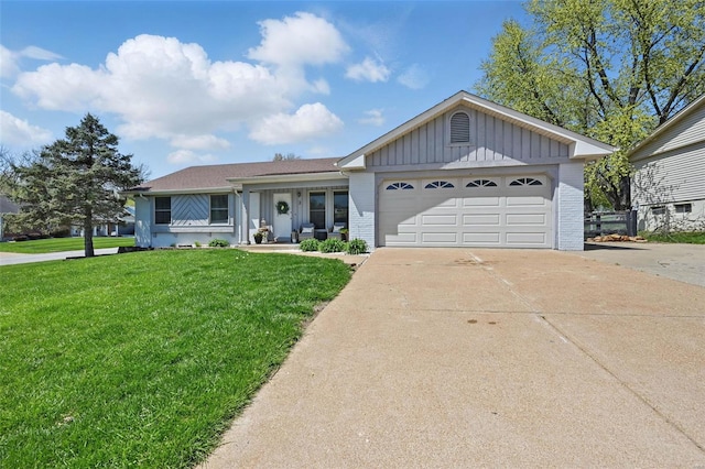 ranch-style home featuring an attached garage, brick siding, concrete driveway, a front yard, and board and batten siding