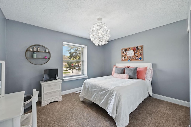 bedroom with a textured ceiling, carpet flooring, and a notable chandelier