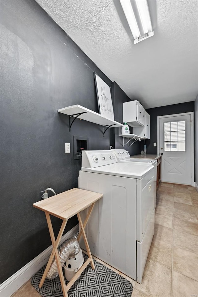 clothes washing area featuring independent washer and dryer and a textured ceiling