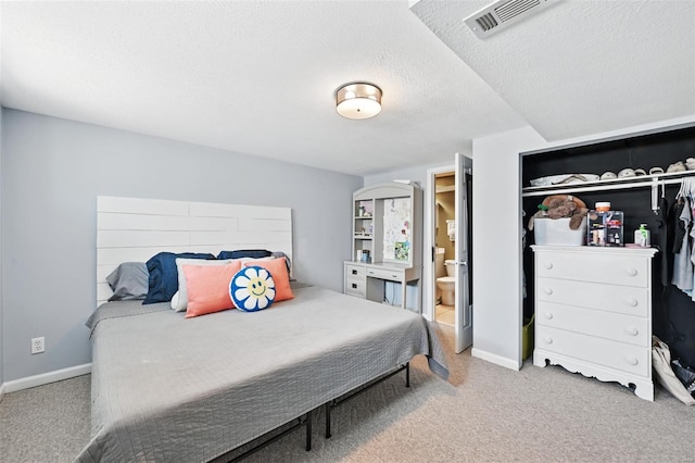 bedroom with a textured ceiling, carpet, and baseboards