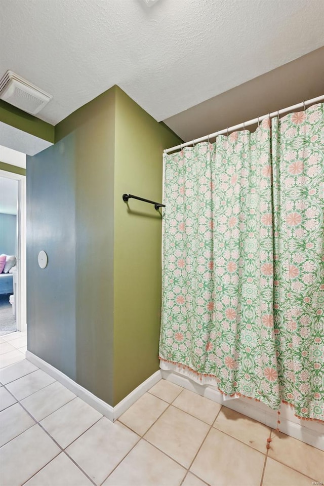 full bathroom with baseboards, tile patterned flooring, visible vents, and curtained shower