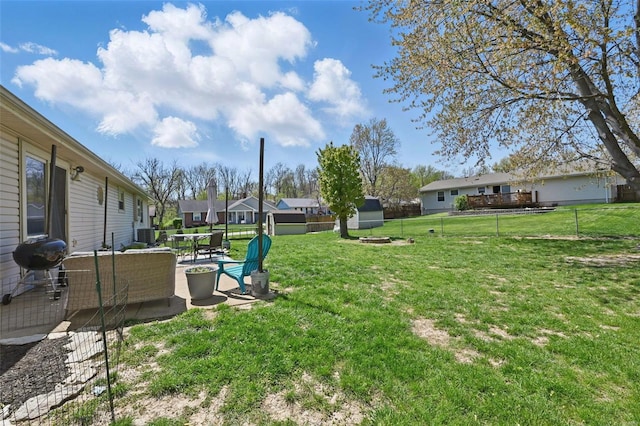 view of yard featuring a patio area, a residential view, and a fenced backyard