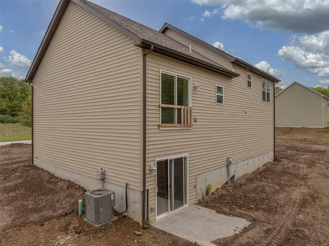 view of side of home featuring central AC unit
