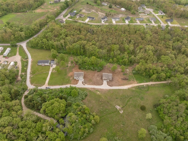 birds eye view of property with a wooded view