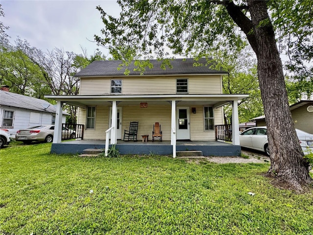 back of house featuring a yard and a porch
