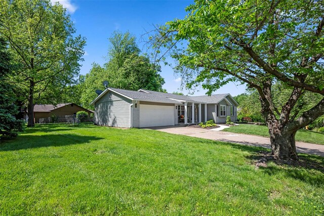 ranch-style home featuring a garage and driveway