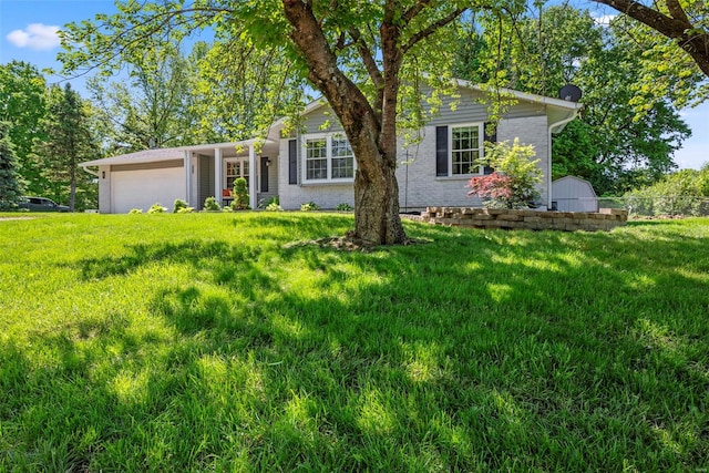 ranch-style home featuring a front lawn, a garage, and brick siding